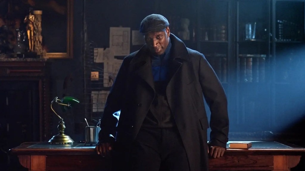 Omar Sy as Assane Diop in a black coat looking sharp in Lupin on Netflix US